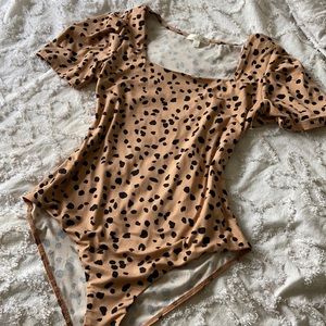 Tan black body suit
